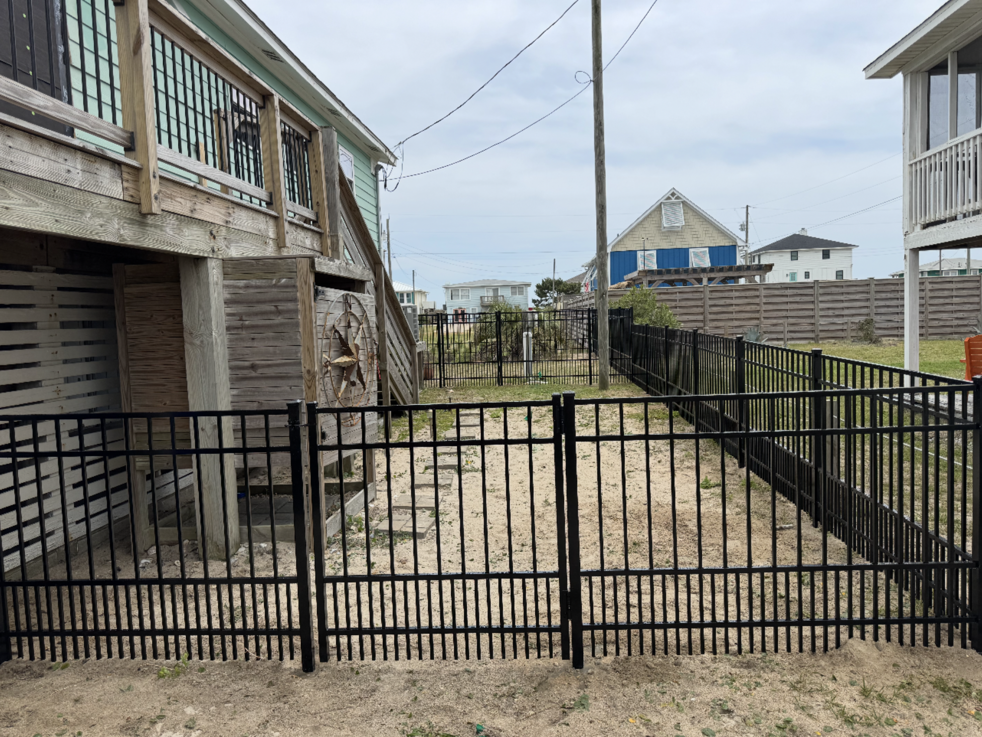 Black aluminum decorative fence installation at beach property in Topsail Island